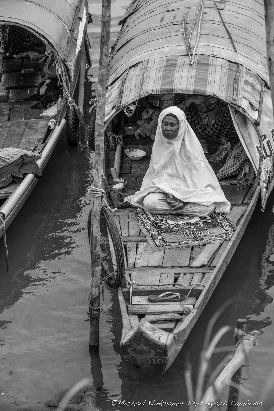 Cham woman praying on boat